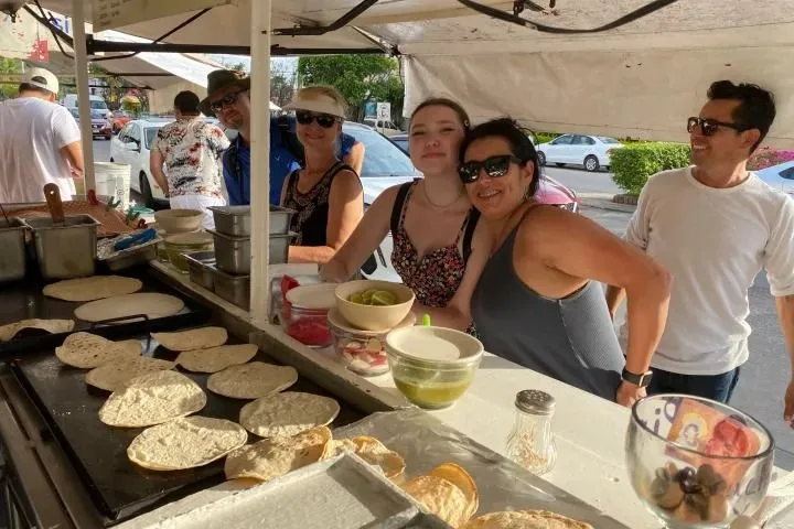 Guests beside freshly cooked tortillas at a neighborhood food stall in Puerto Vallarta