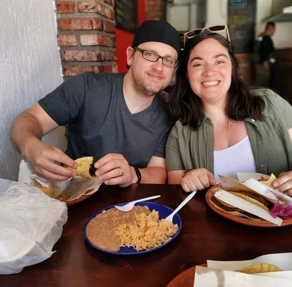 A smiling couple enjoying tacos at a local restaurant on a San José del Cabo food tour
